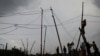 FILE - Locals illegally connect electricity, in Soweto, South Africa January 18, 2022. 