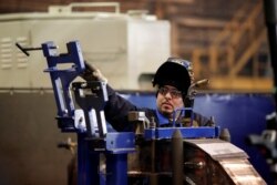 An employee of LB Steel LLC manufactures a component for new Amtrak Acela trains built in partnership with Alstom in Harvey, Ill., Dec. 4, 2019.