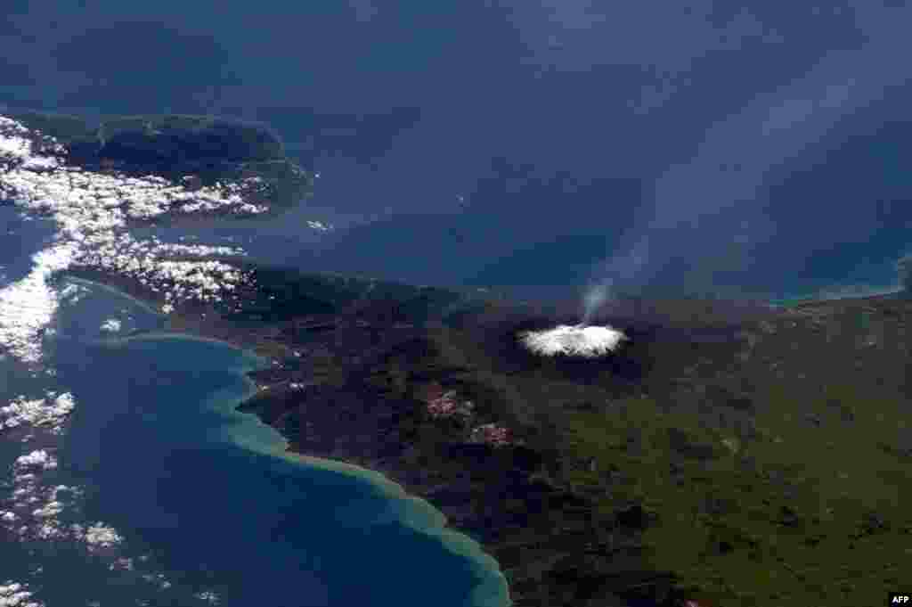 This NASA handout image captured by Canadian astronaut Chris Hadfield on board the International Space Staion (ISS) on Apr. 1, 2013, shows a plume coming from Mt. Etna in Sicily, Italy.