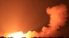 Explosions illuminate the sky during Israeli strikes on Gaza City on October 10, 2023.