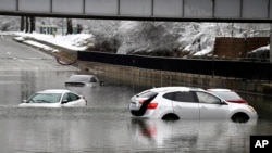 Cars sit in floodwaters at a railroad underpass in Louisville, Kentucky, Feb. 16, 2025.