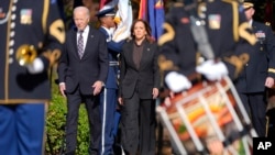 President Joe Biden, left, and Vice President Kamala Harris arrive at a wreath laying ceremony at the Tomb of the Unknown Soldier during a Veterans Day observance at Arlington National Cemetery in Arlington, Virginia, Nov. 11, 2024.