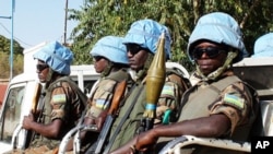 The blue helmets of UN peacekeepers distinguish them from the many armed groups in Darfur.