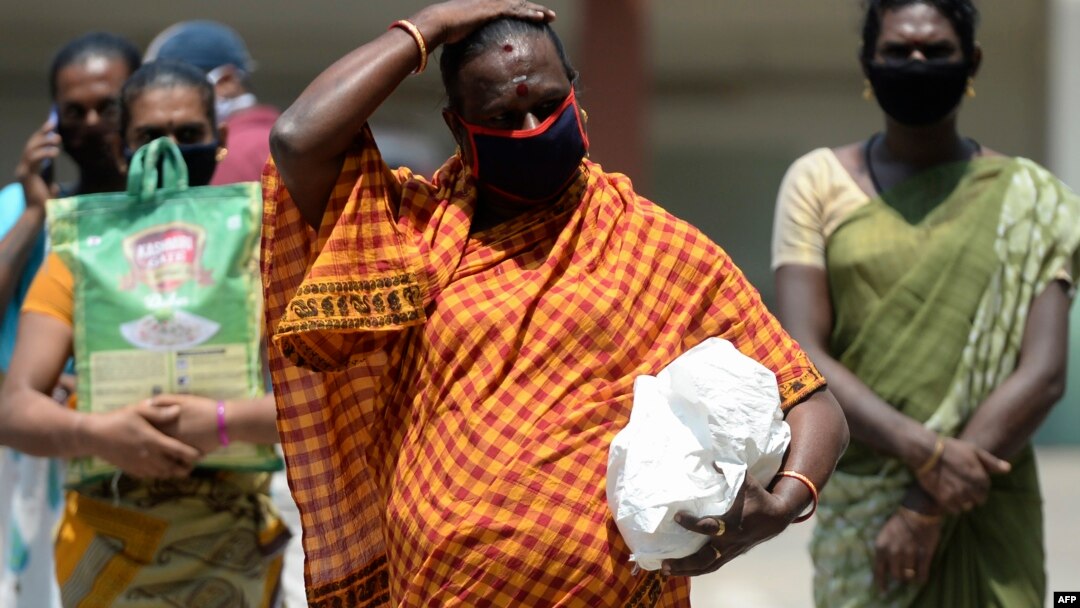 Sejumlah transgender berjalan sambil menjaga jarak aman ketika menerima bantuan makanan gratis di tengah pemberlakuan karantina wilayah untuk mencegah penyebaran Covid-19 di Chennai, India, 1 Mei 2020. (Foto: AFP)
