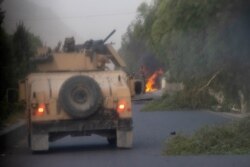 FILE - Humvees that belong to Afghan Special Forces are seen destroyed during heavy clashes with Taliban, in Kandahar province, Afghanistan, July 13, 2021.