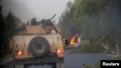 FILE - Humvees that belong to Afghan Special Forces are seen destroyed during heavy clashes with Taliban, in Kandahar province, Afghanistan, July 13, 2021. 