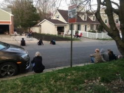 Neighbors watch Bill Crandall play his guitar from his garage in Takoma Park, Maryland. (Mariama Diallo/VOA)