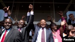 Kenya's presidential candidate Uhuru Kenyatta (C) and his running mate William Ruto (2nd L) celebrate winning the presidential election with supporters after the official result was released in Nairobi, March 9, 2013. 