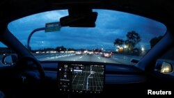 A Model 3 Tesla vehicle navigates morning rush hour using the car's auto pilot feature in Los Angeles, California, March 20, 2019. 