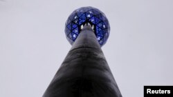 FILE - The Times Square New Year's Eve Ball is tested atop the roof of One Times Square on the day before 2016 New Year's Eve celebrations in New York, Dec. 30, 2015.