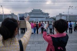 지난해 6월 북한을 방문한 중국인 관광객들이 평양 김일성 광장에서 기념사진을 찍고 있다.