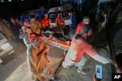 An injured passenger rescued by security forces from a train attacked by insurgents is carried on a stretcher after arriving on a special train for the wounded and survivors at a railway station in Much, in Pakistan's southwestern Balochistan province, March 12, 2025.