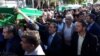 Mourners carry the bodies of three girls who died in a school fire in Iran's southeastern city of Zahedan as part of a funeral procession, Dec. 19, 2018. 