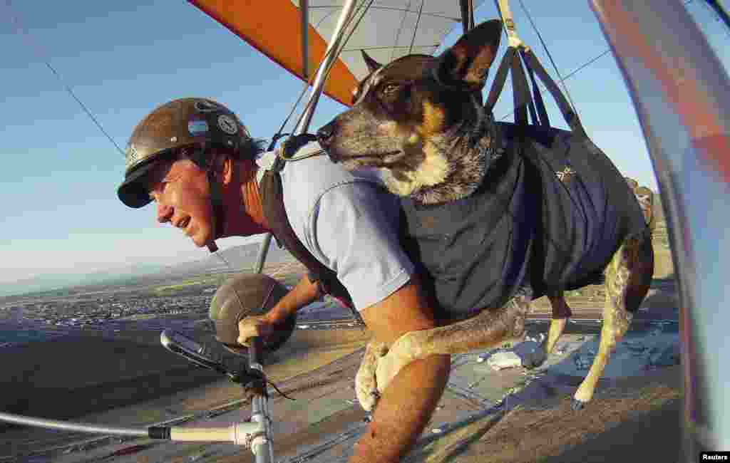 Dan McManus and his service dog Shadow glide together outside Salt Lake City, Utah, USA. McManus suffers from anxiety and Shadow&#39;s presence and companionship help him to manage the symptoms. The two have been flying together for about nine years with a specially made harness for Shadow.
