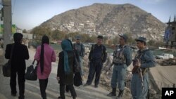 Afghan policemen keep watch near the site where a suicide bomber was killed near the location of the Loya Jirga, or the traditional assembly, in Kabul, November 14, 2011.