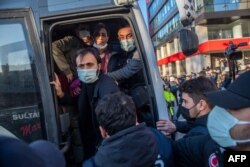 Turkish police officers detain protesters during a rally in support of Bogazici University students protesting the appointment of Melih Bulu, a ruling Justice and Development Party loyalist, as rector of the university, in Istanbul, Feb. 4, 2021.