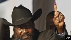 South Sudan's President Salva Kiir shows his finger, inked after casting his vote, during the referendum in Juba, south Sudan, 09 Jan 2011.