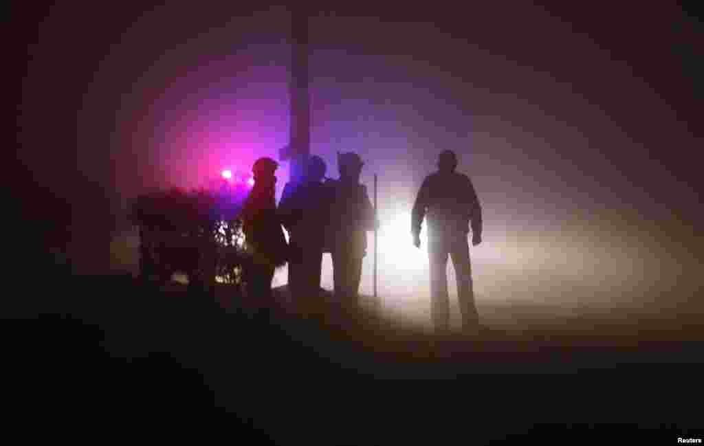 Policemen stand guard outside the cremation ground during the funeral of a rape victim after her body arrived from Singapore, in New Delhi, December 30, 2012. 