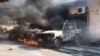 Cars burn after angry police protesters set fire to them at the Ministry of Finance. (VOA Creole/Matiado Vilme)