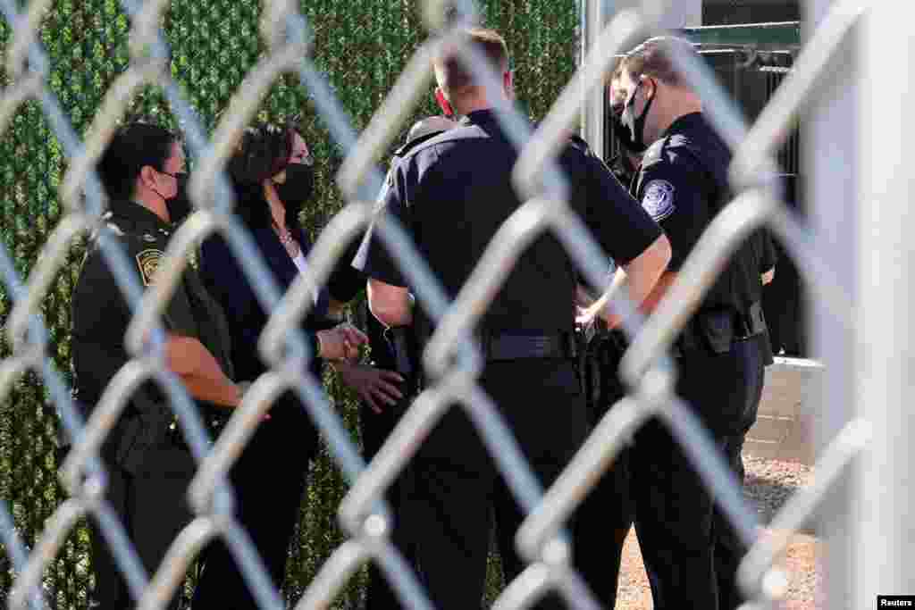 U.S. Vice President Kamala Harris speaks with members of the U.S. Border Patrol as she visits El Paso central processing center, near the border between the United States and Mexico in El Paso, Texas.