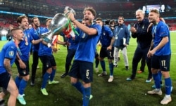 Italy's players celebrate with trophy after winning the Euro 2020 soccer championship final match between England and Italy at Wembley Stadium in London, July 11, 2021.