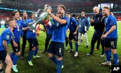 Italy's players celebrate with trophy after winning the Euro 2020 soccer championship final match between England and Italy at Wembley Stadium in London, July 11, 2021.