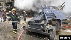 A damaged vehicle of the Iraqi security forces is seen at the site of a car bomb attack in Baghdad al-Jadeeda, an eastern district of the Iraqi capital, June 9, 2016. 