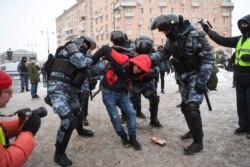 FILE - Riot police detain a man during a rally in support of jailed opposition leader Alexey Navalny in Moscow, Russia, Jan. 31, 2021.