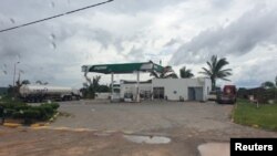 A damaged Puma Energy gas station is pictured from inside a vehicle after Cyclone Kenneth swept through the region in Cabo Delgado province, Mozambique, April 26, 2019, in this image obtained from social media.