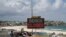 People walk past a "Beach Closed" sign at Bondi Beach in Sydney, Australia, on April 1, 2020. The beach remains closed to prevent the spread of COVID-19.