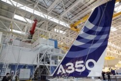 FILE - The vertical tail wing of an Airbus A350 is seen on the final assembly line in Toulouse, southwestern France, Oct. 23,2012.