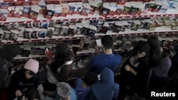 People look at books at the 20th International Book Fair in Algiers, Algeria, Nov. 02, 2015. 