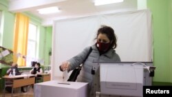 A woman votes in a polling station during parliamentary elections in Sofia, Bulgaria, Apr. 4, 2021. 