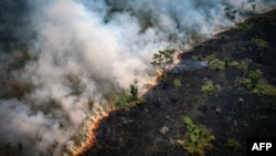 Aerial view of a burnt area in the Amazon rainforest near the Lago do Cunia Extractive Reserve in northern Brazil, on Aug. 31, 2022. Experts say Amazon fires are caused mainly by illegal farmers, ranchers and speculators clearing land and torching the trees.