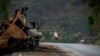 FILE - A man crosses near a destroyed truck on a road leading to the town of Abi Adi, in the Tigray region of northern Ethiopia, May 11, 2021. A spokesman for Tigrayan authorities said Sept 20, 2022, that Eritrea had launched a full-scale offensive along 