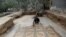 Palestinian farmer Salman al-Nabahin cleans a mosaic floor he discovered at his farm and which dates back to the Byzantine era, according to officials, in the central Gaza Strip, Sept. 18, 2022.