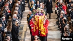 FILE: The coffin of Queen Elizabeth II, draped in the Royal Standard with the Crown and the Sovereign's orb and scepter, as it is carried out of Westminster Abbey after her State Funeral. Picture date: Monday September 19, 2022. The Royal Scepter carries the Star of Africa.
