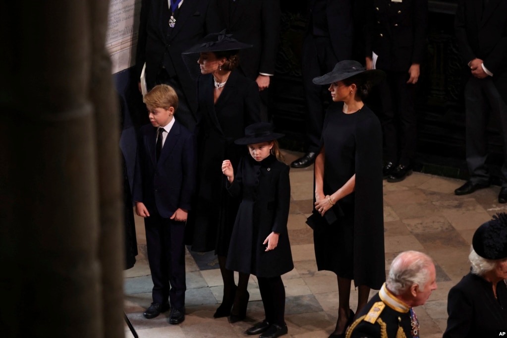 Kate, Princess of Wales, Meghan, Duchess of Sussex, Prince George and Princess Charlotte arrive at the Westminster Abbey for the state funeral of Queen Elizabeth, in London, Sept. 19, 2022.