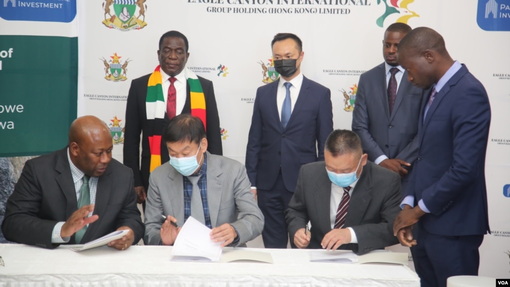 Zimbabwe Mines Minister Winston Chitando, left, participates in the signing of a $2.8 billion investment deal in Harare with officials from
Eagle Canyon International Group Holding Ltd., Sept. 16, 2022. (Columbus Mavhunga/VOA)