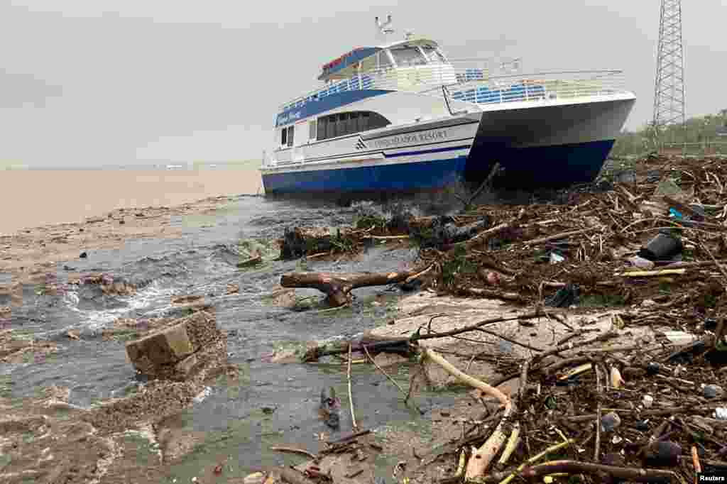 A boat lies washed up on shore after the passing of Hurricane Fiona in Ponce, Puerto Rico, Sept. 19, 2022.