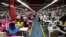 FILE - Employees work on the manufacturing line at the United Aryan Export Processing Zone textile factory in Nairobi, Kenya April 13, 2017. 