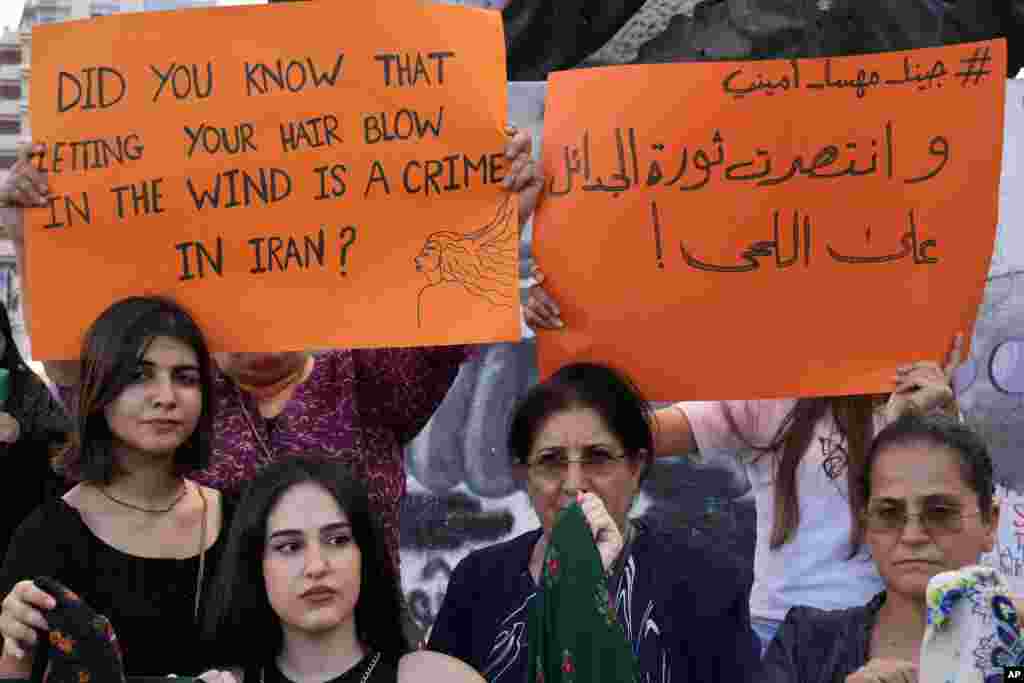 Kurdish women activists hold up placards during a protest against the death of Iranian Mahsa Amini in Iran, at Martyrs' Square in downtown Beirut, Lebanon, Sept. 21, 2022.