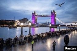 People queue to pay their respects to Queen Elizabeth, following her death, in London, Sept.18, 2022.