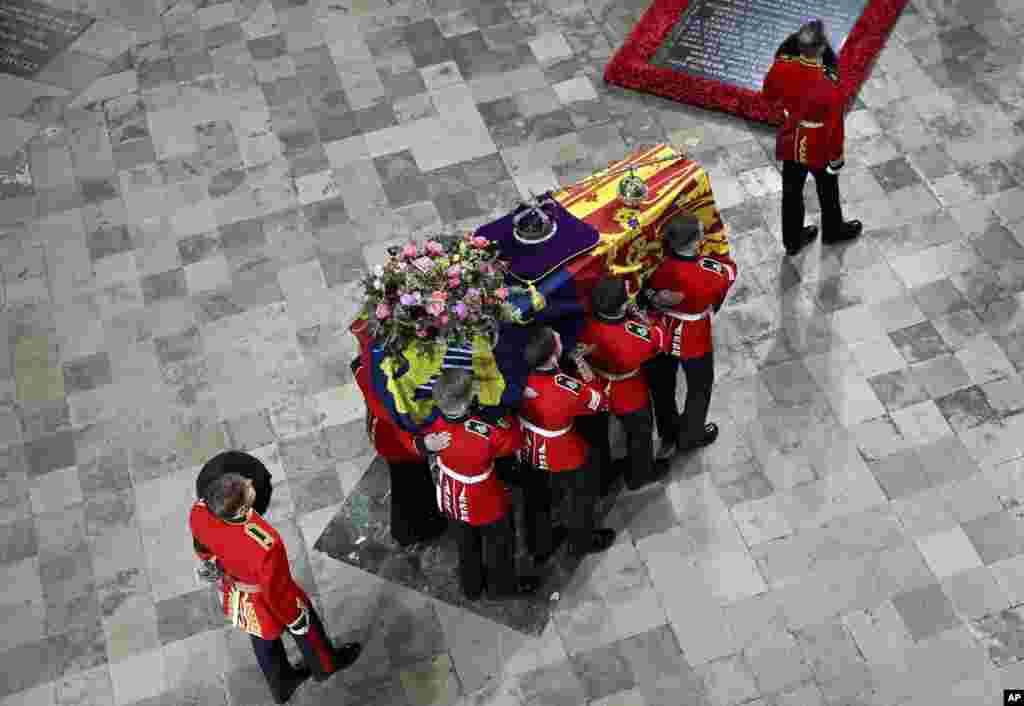 The coffin of Britain's Queen Elizabeth II is carried into Westminster Abbey ahead of her State Funeral, in London, Sept. 19, 2022. 
