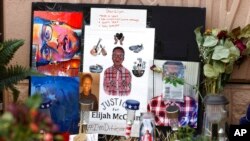 FILE - A makeshift memorial stands at a site across the street from where Elijah McClain was stopped by Aurora, Colo., Police Department officers while walking home, before family members hold a news conference, July 3, 2020, in Aurora, Colo.