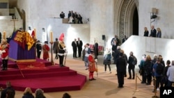 US President Joe Biden and First Lady Jill Biden, far right, view the coffin of Queen Elizabeth II lying in state on the catafalque in Westminster Hall, at the Palace of Westminster, London, Sept. 18, 2022.