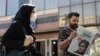 A man views a newspaper with a cover picture of Mahsa Amini, a woman who died after being arrested by the Islamic republic's "morality police" in Tehran, Iran, Sept. 18, 2022. (Majid Asgaripour/WANA via Reuters)