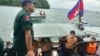 Chinese nationals get off from a speedboat after being rescued from a ship sinking, at an island in Preah Sihanouk Province, southwestern Cambodia on Thursday, Sept. 22, 2022. (Preah Sihanouk province Authority Police via AP) 