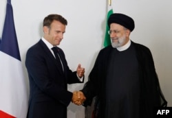 FILE - French President Emmanuel Macron holds a bilateral meeting with Iranian President Ebrahim Raisi on the sidelines of the 77th United Nations General Assembly at UN headquarters in New York City, Sept. 20, 2022.