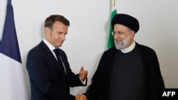 FILE - French President Emmanuel Macron holds a bilateral meeting with Iranian President Ebrahim Raisi on the sidelines of the 77th U.N. General Assembly at U.N. headquarters in New York City, Sept. 20, 2022. 